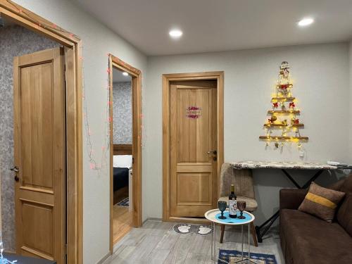 a living room with a christmas tree on the wall at Kitesa's cozy apartment in Mtskheta