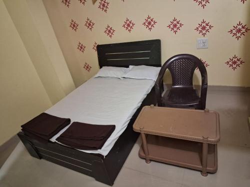 A bed or beds in a room at Hotel Sai Satya