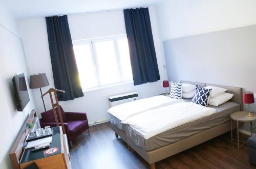 Cama ou camas em um quarto em Pécs Centrum Apartman