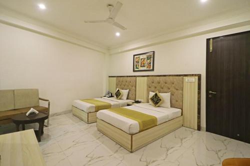 ein Hotelzimmer mit 2 Betten und einem Schreibtisch in der Unterkunft HOTEL The Almora By RS Global in Neu-Delhi