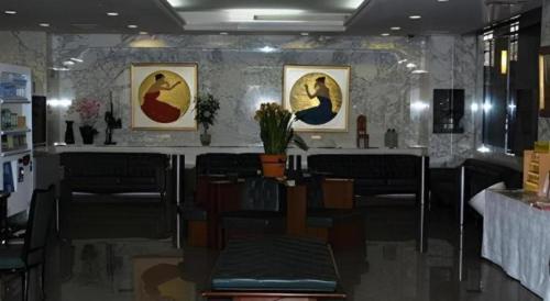 a restaurant with paintings of birds on the wall at Albert Hotel in Akita