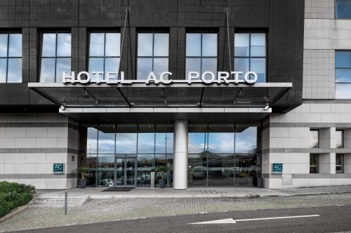 um sinal de hotel ac porto na frente de um edifício em AC Hotel Porto by Marriott no Porto