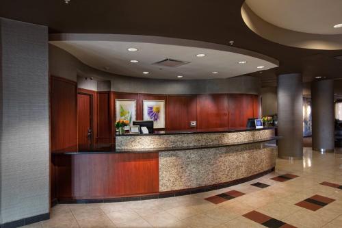 a lobby with a bar in a hotel at Courtyard by Marriott Fayetteville in Fayetteville