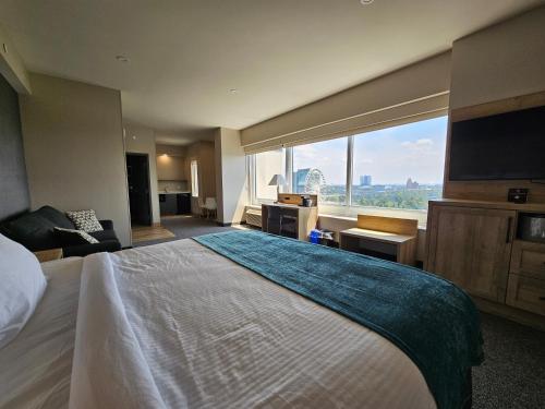 een hotelkamer met een groot bed en een groot raam bij Vittoria Hotel & Suites in Niagara Falls