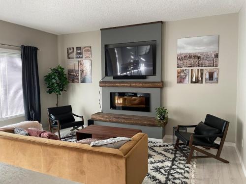 sala de estar con sofá y TV en Cozy 3 Bedroom home, en Spruce Grove