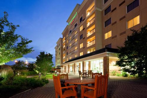 une table et des chaises en face d'un hôtel dans l'établissement Courtyard by Marriott Toronto Markham, à Markham