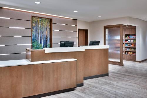 an office lobby with a reception desk and a book shelf at Fairfield Inn & Suites by Marriott Denver West/Federal Center in Lakewood