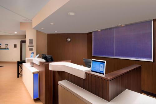 a hospital room with a laptop on a counter at Fairfield Inn & Suites by Marriott Albuquerque Airport in Albuquerque