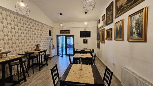 a restaurant with tables and chairs in a room at Neferprod Apartments - IS - CAM 02 in Timişoara