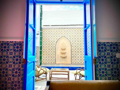 an open door to a room with a table and chairs at Dar Saida in Sidi Bou Saïd