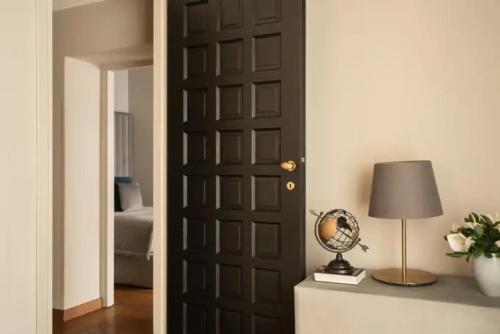 a door in a room with a lamp and a globe at La Residenza del Sole al Pantheon in Rome