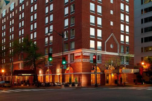 a tall red brick building with a green traffic light at Fairfield Inn & Suites by Marriott Washington Downtown in Washington