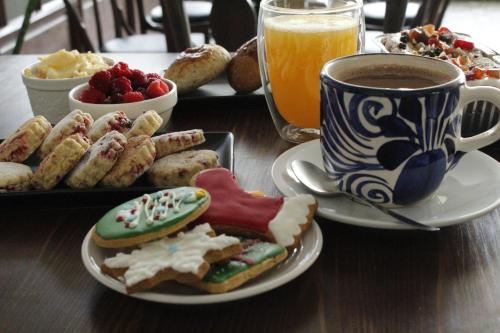 a table with a plate of food and a cup of coffee at Kunan Hotel in Cochabamba