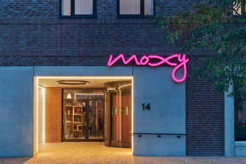 a neon sign on the side of a building at Moxy Bremen in Bremen