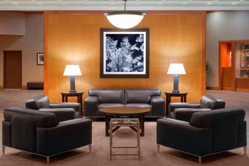 a waiting room with leather furniture and a table at Sheraton Denver West Hotel in Lakewood