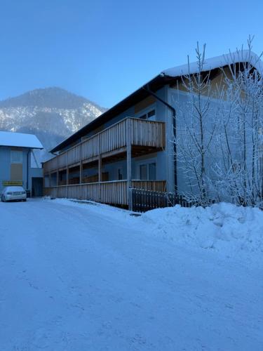 a building in the snow with a car parked in front at Zeffererhof in Schladming