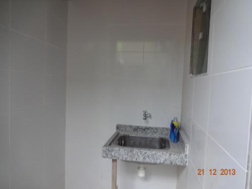 a bathroom with a sink in a white wall at Casa de praia in Paraty