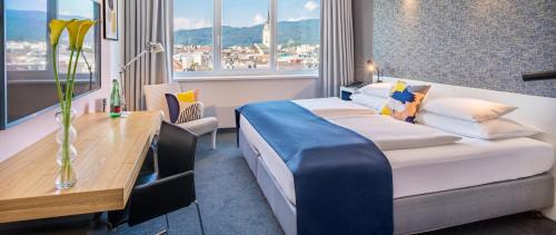 Gulta vai gultas numurā naktsmītnē voco® Villach, an IHG Hotel