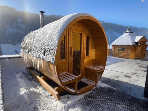 a wooden cabin with snow on top of it at Sun Chalet in Schladming