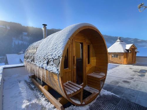 a large wooden cabin with snow on the roof at Sun Chalet in Schladming