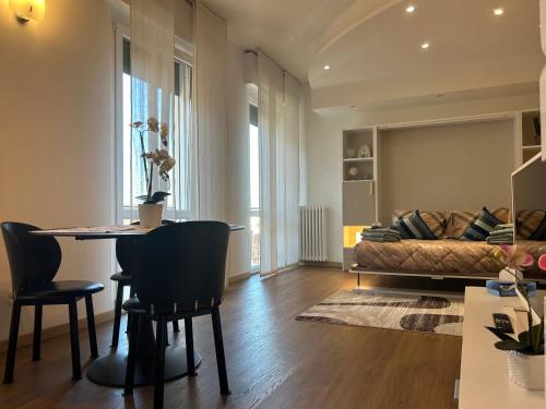 a living room with a table and a couch at Valverde Apartment and Rooms in Verona