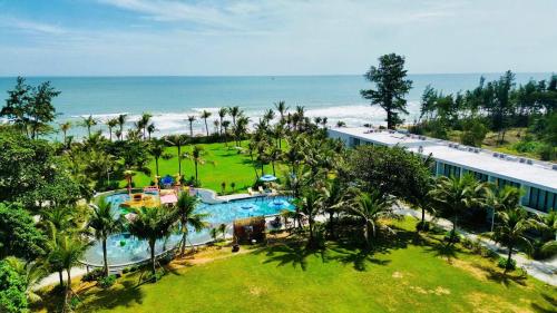 ファンティエットにあるThe Vista Beach Resort Phan Thiếtのスイミングプールと海を望むリゾートの空中ビュー