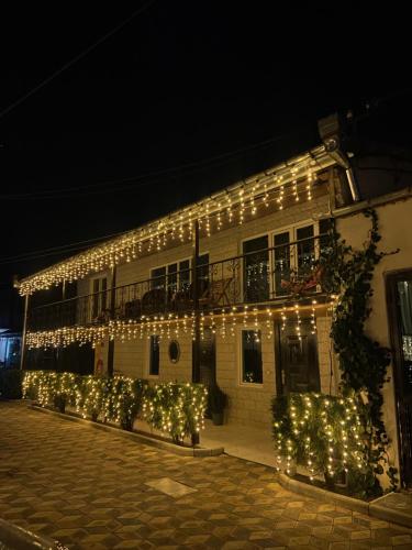 a building with christmas lights on the side of it at Hotel Doko in Martvili