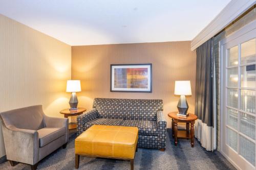 a living room with a couch and a chair at Embassy Suites by Hilton Bloomington/Minneapolis in Bloomington