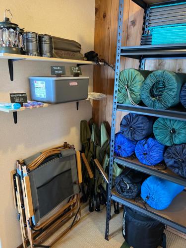 a room with shelves with blue and green plates at ASTERISK＋ in Iwami