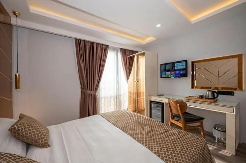 A bed or beds in a room at Luxury Airport Hotel