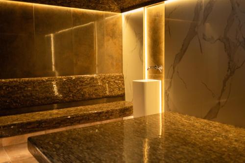 a bathroom with a granite counter top with a candle at Continental SPA Resort in Bukovel