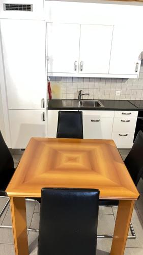 a kitchen with a wooden table and chairs at Quiet Flat in Nature in Lugano in Lugano