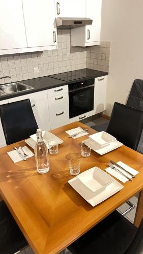 a kitchen with a wooden table with chairs and a counter at Quiet Flat in Nature in Lugano in Lugano