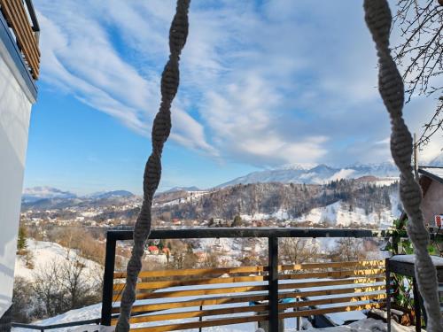 a view of the mountains from the balcony of a house at Touch the Sky in Moieciu de Jos