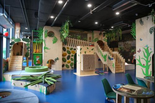 a childrens play room with a slide and stairs at Mazurski Raj - Hotel, Marina & Spa in Ruciane-Nida