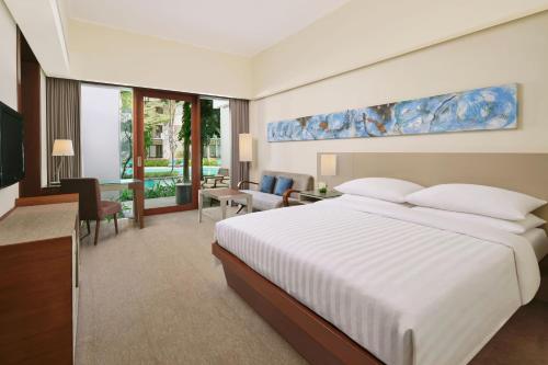 1 dormitorio con 1 cama y sala de estar en Courtyard by Marriott Bali Nusa Dua Resort, en Nusa Dua