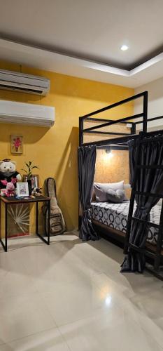 a bedroom with two bunk beds and a table at Eat n Sleep in Phuket Town