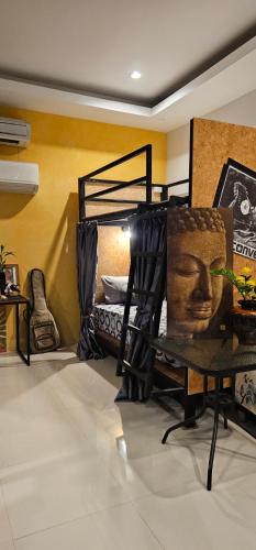 a room with a bed with a head on it at Eat n Sleep in Phuket Town