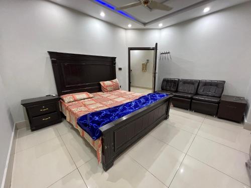 a bedroom with a large bed and a mirror at Palm View Residences in Gujrānwāla