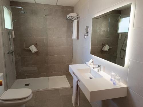 a bathroom with a toilet and a sink and a shower at Mendez Nuñez Alicante in Alicante