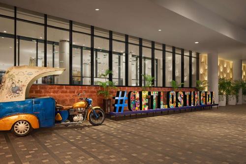 a scooter parked in front of a building at Hyatt Centric Candolim Goa in Calangute