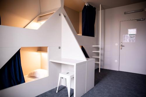 a small room with a white bunk bed and a stool at The People - Tours in Tours