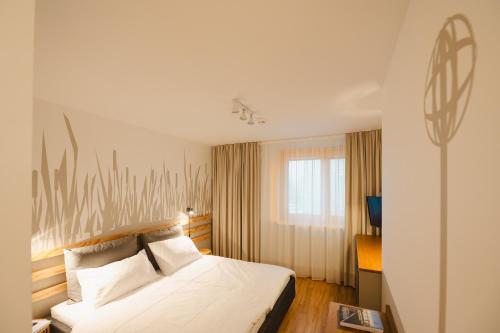 a hotel room with a bed and a window at HausPension in Vienna