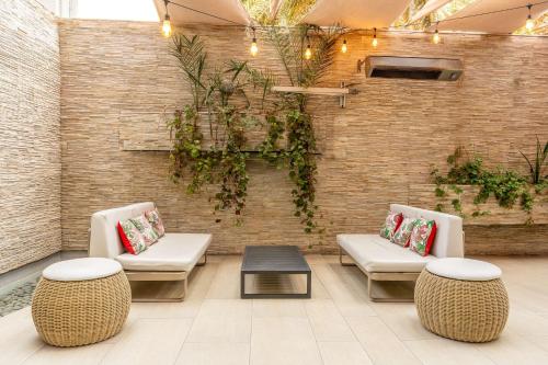 a lobby with two chairs and a table and a brick wall at Hilton Garden Inn Iquique in Iquique