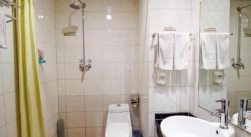 a bathroom with a shower and a toilet and a sink at Super 8 Hotel Xian Nanshaomen in Xi'an