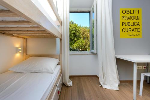 Hostel EuroAdria في دوبروفنيك: غرفة نوم صغيرة مع سرير بطابقين ونافذة