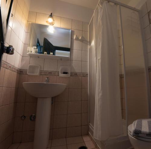 a bathroom with a sink and a shower with a mirror at Archipelagos in Naxos Chora