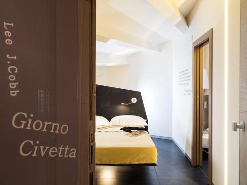 A bed or beds in a room at Duomo Suites & Spa