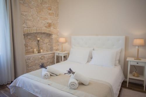 ein Schlafzimmer mit einem weißen Bett und Handtüchern darauf in der Unterkunft Barone Room in Šibenik