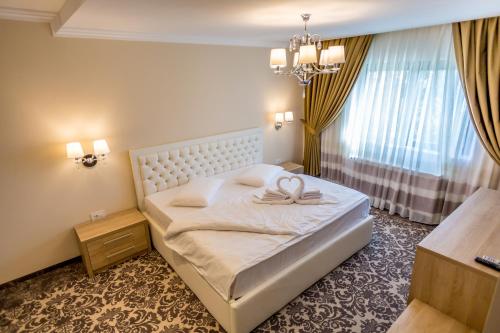 Postel nebo postele na pokoji v ubytování J'adore Boutique Hotel